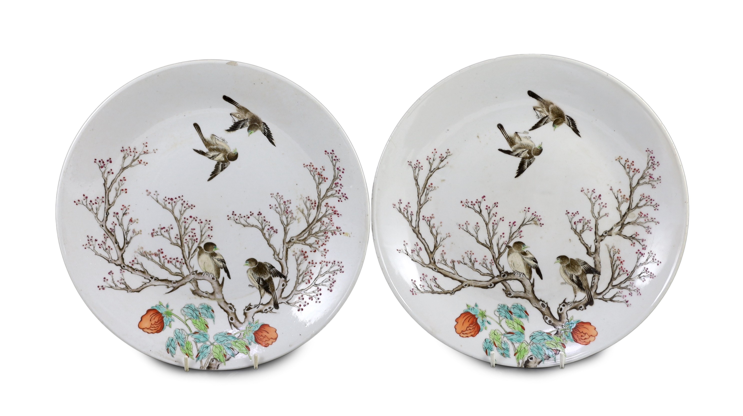 A pair of Chinese enamelled porcelain 'blackbird' dishes, Qianlong seal marks but 19th century, 27cm diameter, minor damage